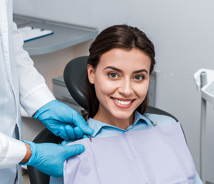 Smiling woman in the dental chair at a dental office in Justin