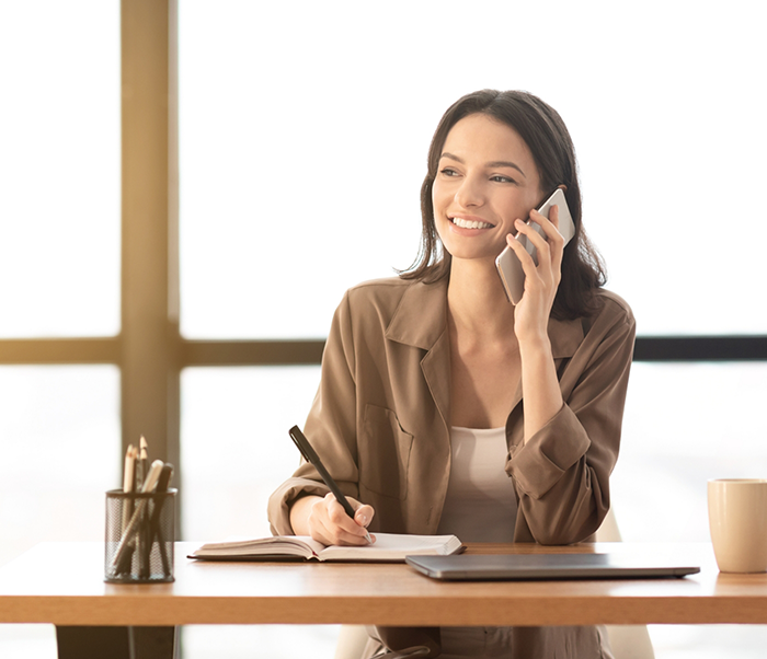 Woman talking on the phone with Justin dental office