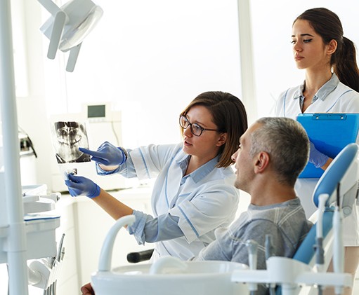 Dentist in Justin looking at X-rays before a dental crown