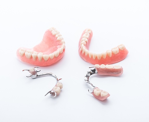 a close-up of a patient holding dentures