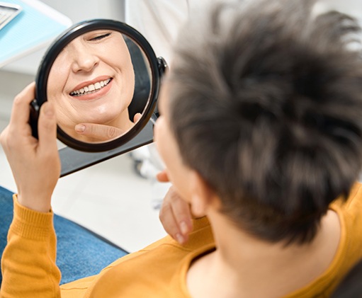 a patient with dentures smiling confidently 