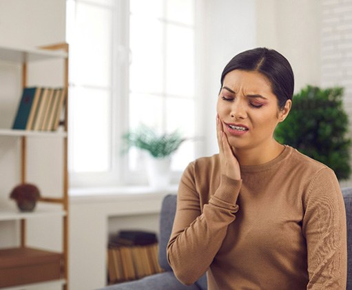 Closeup of woman experiencing toothache at home