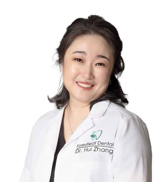 Justin dentist Doctor Hui Zhang smiling in a white lab coat