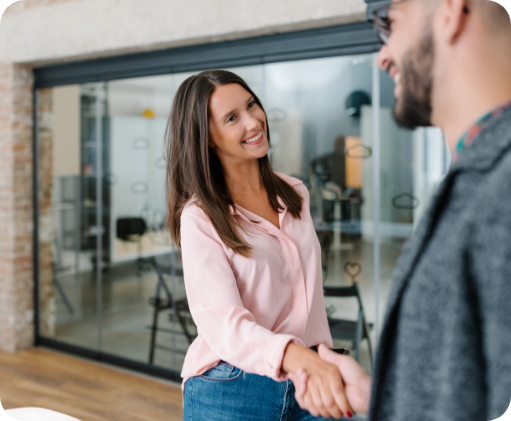 Smiling woman shaking hands with a man