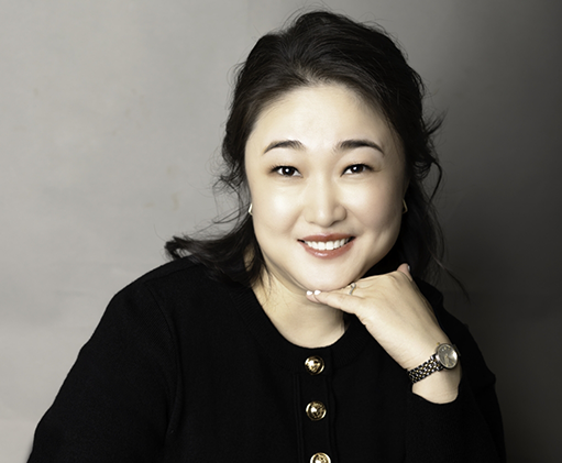 Doctor Zhang smiling in a black blouse