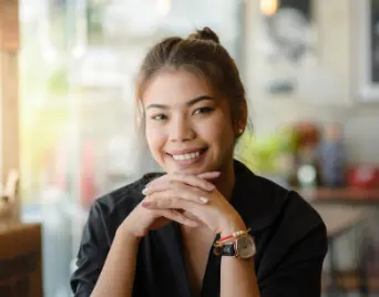 Young woman smiling at a cafe table