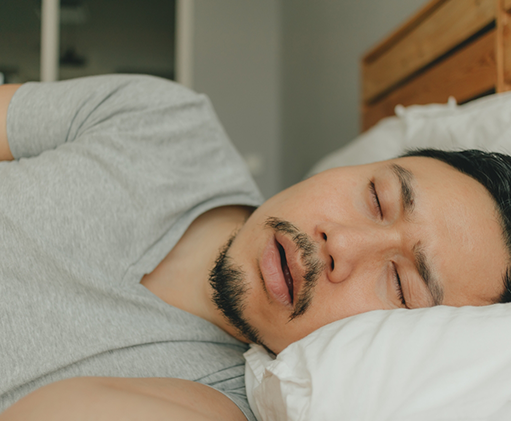 Man sleeping on his side with his mouth open