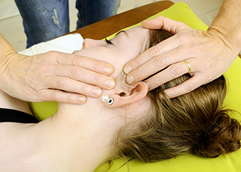 Dentist feeling a patients jaw joint