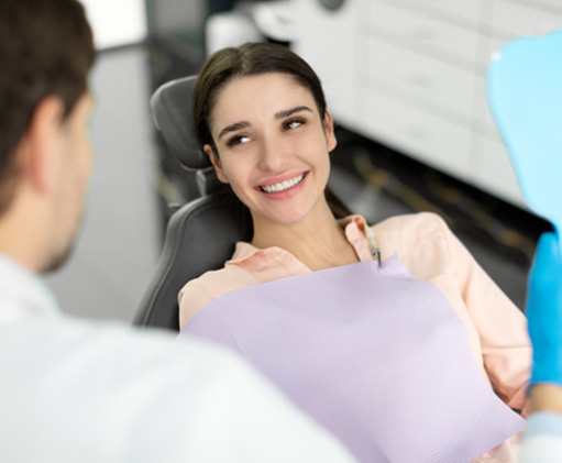 Cosmetic dentistry patient smiling at her dentist