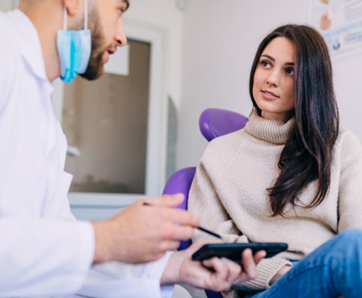 Patient and dentist discussing cost estimate for treatment