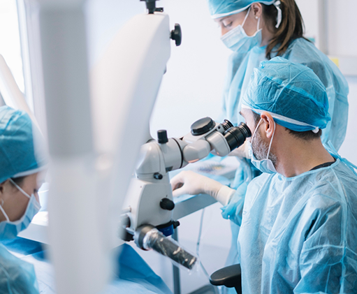 Three dental professionals performing wisdom tooth extractions on a patient