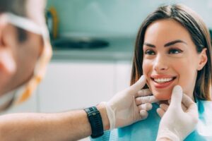 Woman having smile examined by dentist.